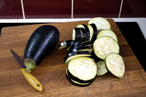 3 aubergines, 2 of which have been sliced