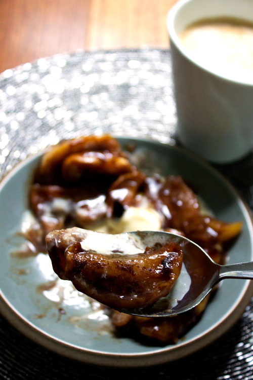 a spoon of baked fruit salad with a little melting icecream
