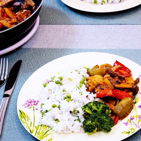 Beef Orange and Bell Pepper Stir-fry with rice, peas and broccoli