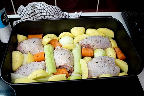 Seasoned chicken and vegetables crammed-in on a roasting tin<