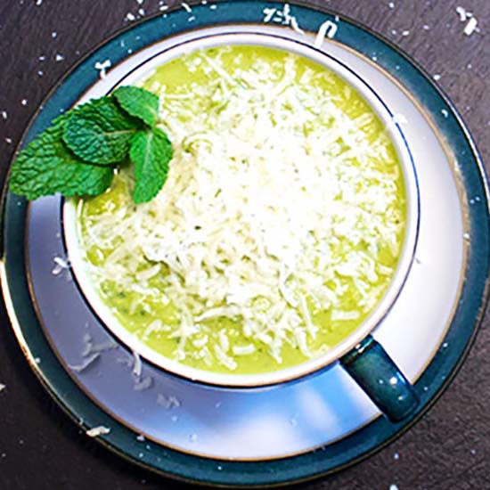 Easy Peasy Pea Mint Soup topped with grated Parmesan cheese