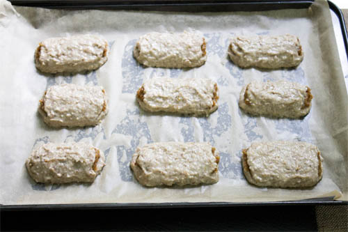lined baking tin with 9 two-inch fig rolls ready to bake