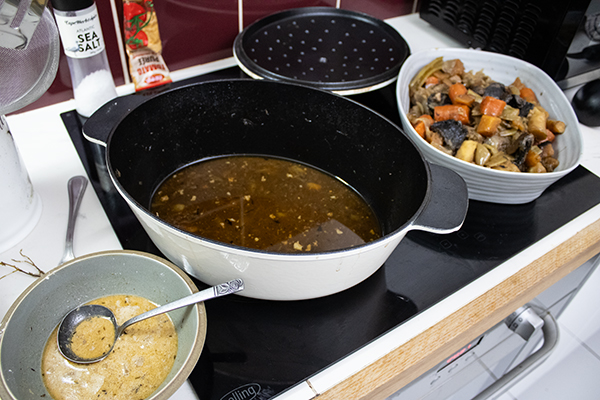 slurry for gravy, juices from roast, vegetables and meat in a serving dish