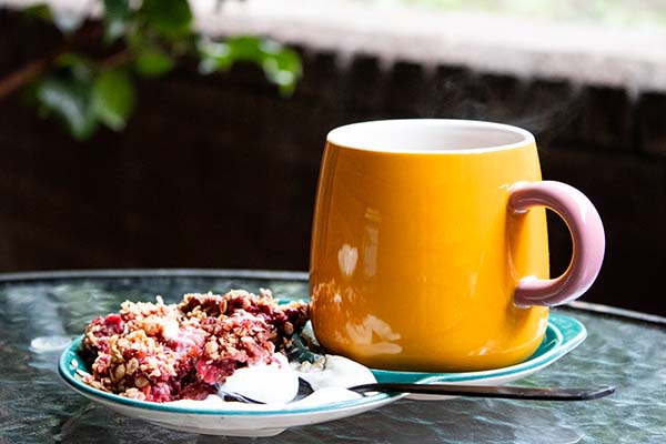 Raspberry Strawberry crumble with a little yoghurt and cup of coffee