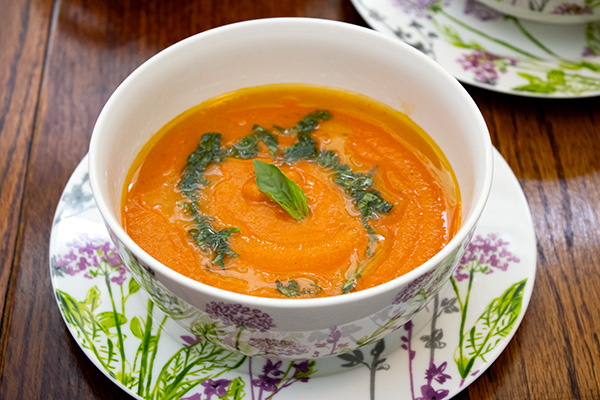 Yellow Split Pea Soup with Roasted Tomatoes, Red Peppers and Garlic and a basil oil garnish