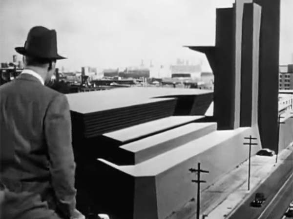 Howard looking at one of his buildings